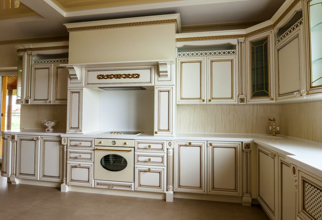 Luxury modern fitted kitchen interior. Kitchen in luxury home with beige cabinetry.